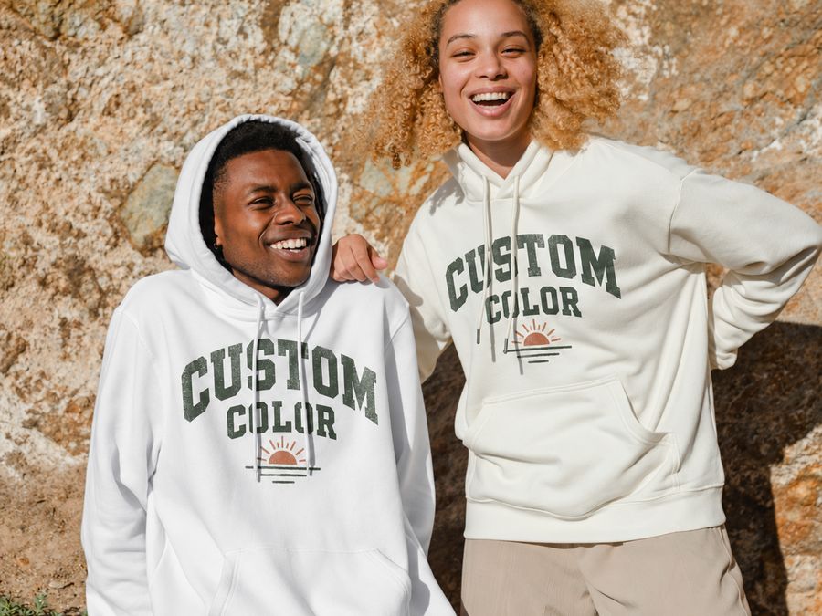Two friends in white hoodies printed with a varsity-style Custom Color design