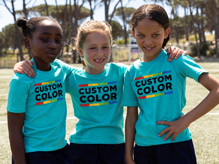 Three kids in matching teal team tees printed with the Custom Color logo